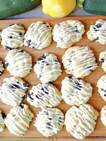 A baking sheet filled with Zucchini Ricotta Cookies that are drizzled with icing.