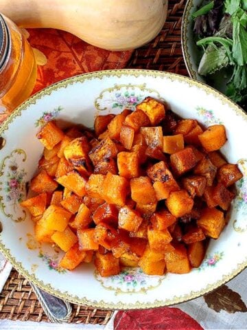 A pretty china serving dish filled with Honey Roasted Butternut Squash.