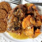 Apple Cider Braised Chicken with sweet potatoes on a plate with gingersnap cookies.