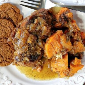 Apple Cider Braised Chicken with sweet potatoes on a plate with gingersnap cookies.