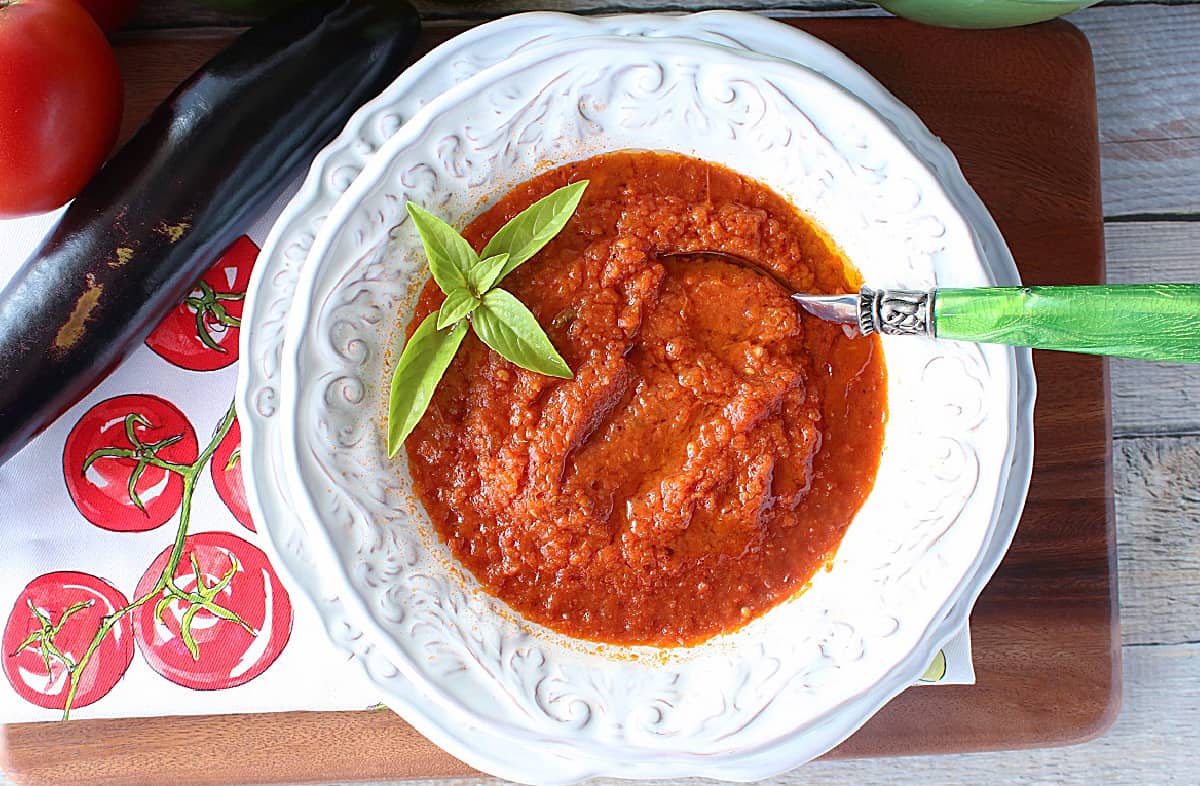 A tomato printed napkin next to a bowl of Roasted Tomato and Vegetable Soup.