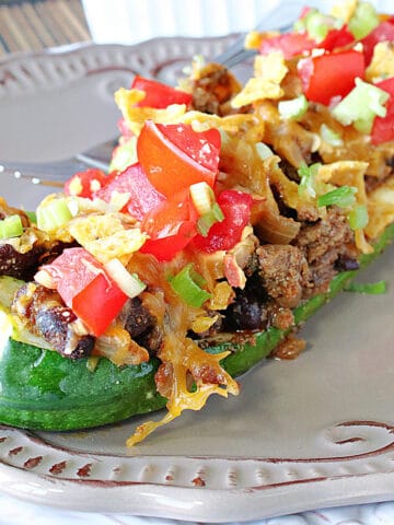 A zucchini filled with taco ingredients.