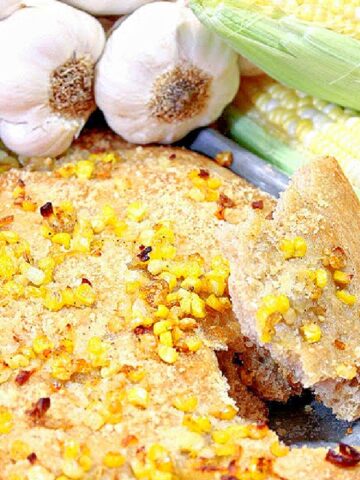 A Garlic Focaccia with Sweet Corn bread with garlic and corn in the background.