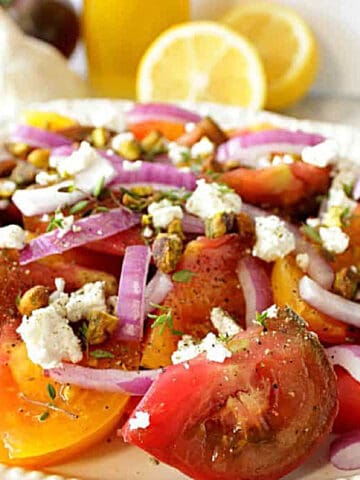 A colorful Heirloom Tomato Salad with feta cheese and red onion.