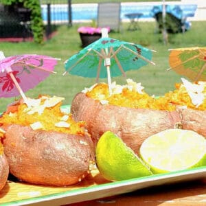 A tray of Tropical Sweet Potato Boats with colorful drink umbrellas.