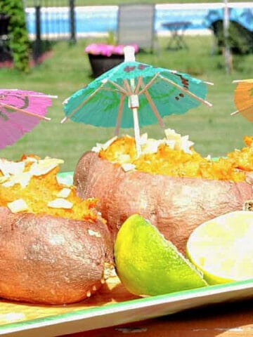 A tray of Tropical Sweet Potato Boats with colorful drink umbrellas.