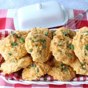 Cheddar Bay Biscuits in a basket with a red and white checked napkin.