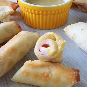 The inside of a Ham and Cheese Eggroll that's been dipped into sauce.