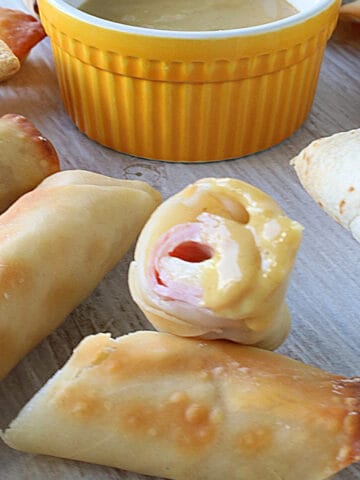 The inside of a Ham and Cheese Eggroll that's been dipped into sauce.