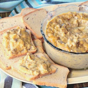 Cocktail rye bread with a bowl of Patty Melt Dip on a plate.