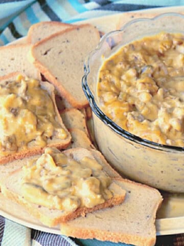 Cocktail rye bread with a bowl of Patty Melt Dip on a plate.