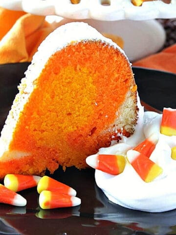 A colorful slice of Candy Corn Pound Cake on a black plate.