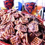 A bowl of Cinnamon Praline Pretzels with Chicago Bears glasses in the background.