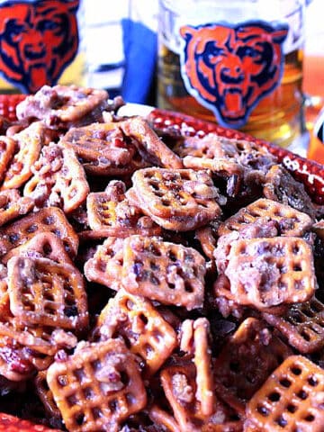 A bowl of Cinnamon Praline Pretzels with Chicago Bears glasses in the background.