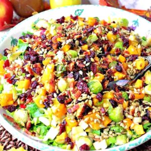 A super colorful Fall Chopped Salad with cranberries, Brussels sprouts, pears, and bacon.
