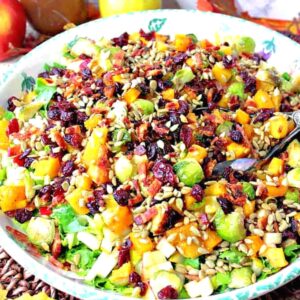 A super colorful Fall Chopped Salad with cranberries, Brussels sprouts, pears, and bacon.