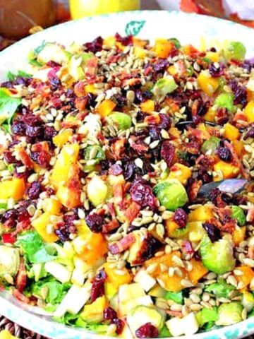 A super colorful Fall Chopped Salad with cranberries, Brussels sprouts, pears, and bacon.