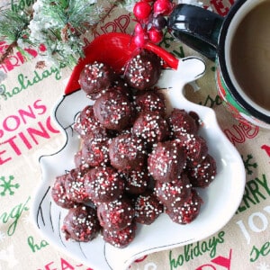 A Santa plate filled with a pile of Chocolate Peppermint Coffee Drops with red and white sugar on top.