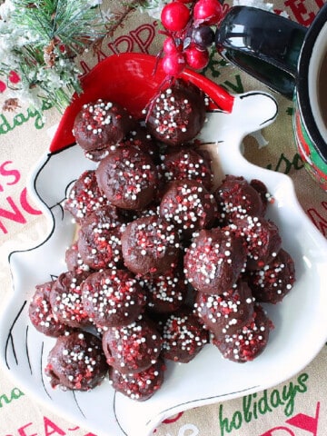 A Santa plate filled with a pile of Chocolate Peppermint Coffee Drops with red and white sugar on top.