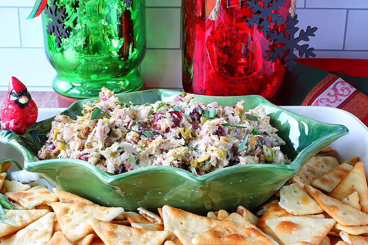 A festive Christmas Chicken Salad in a holly berry bowl with a cardinal.