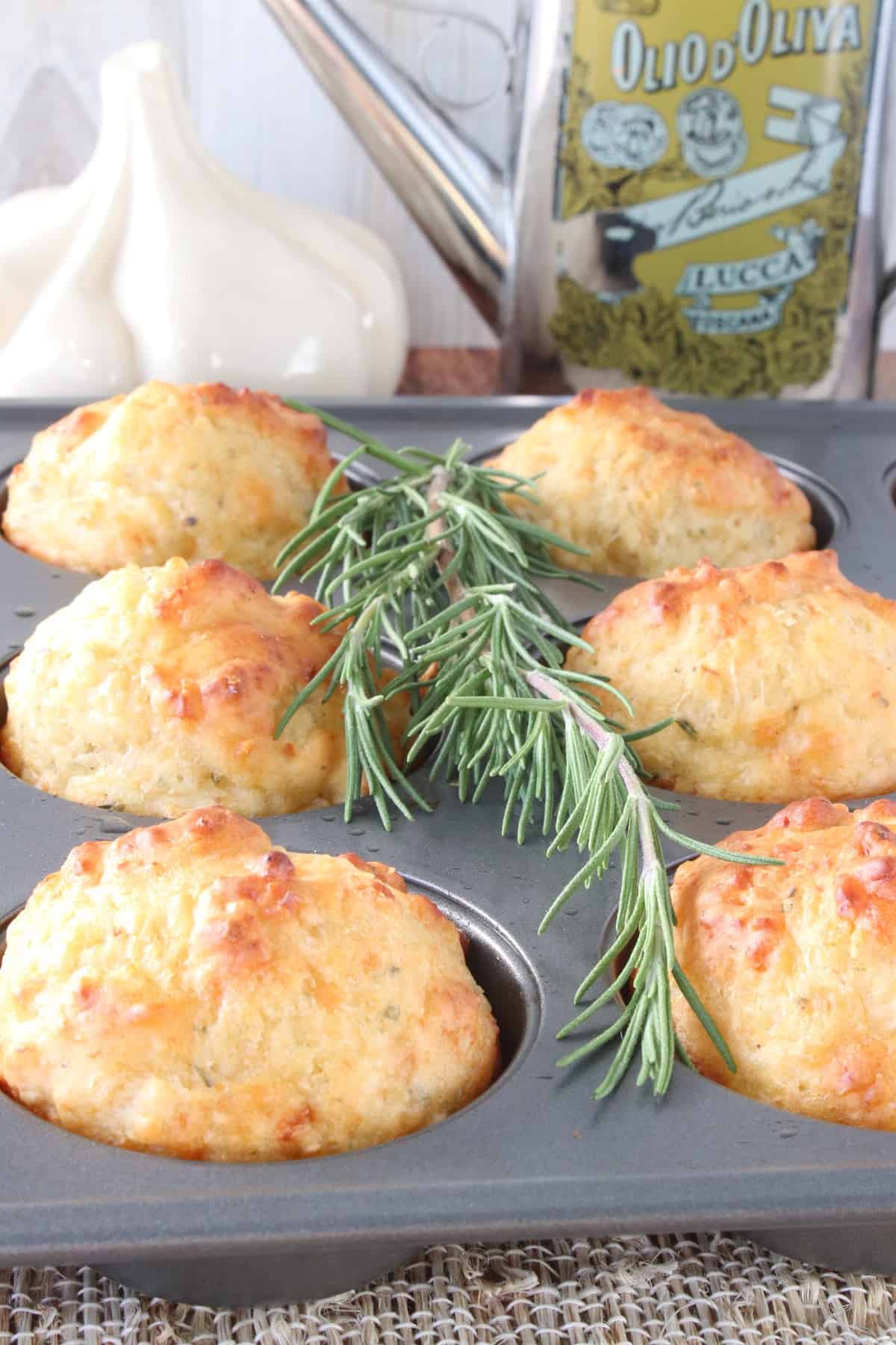 A muffin tin filled with golden brown baked Garlic Rosemary Focaccia Muffins.
