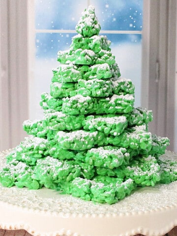 A pretty green Rice Krispies Christmas Tree with confectioners' sugar snow.