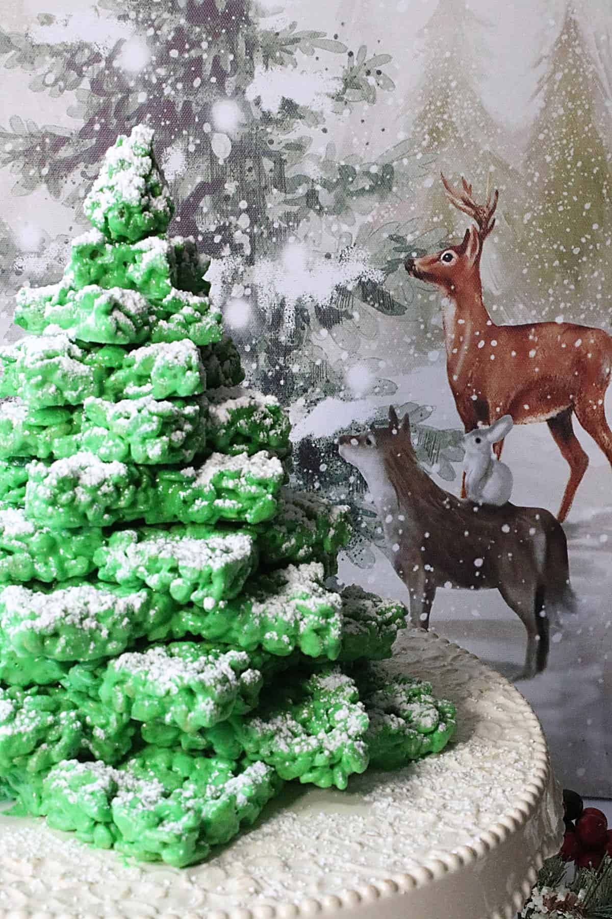 A woodland scene with a Rice Krispies Christmas Tree and animals in the background.