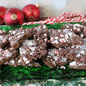 A pile of Cocoa Krispies Peppermint Bark candy on a green glass platter.