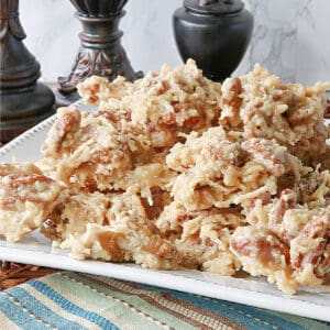 A white plate filled with Coconut Pecan Praline Candy.