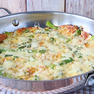 A silver skillet filled with a baked Asparagus and Gruyere Popover.