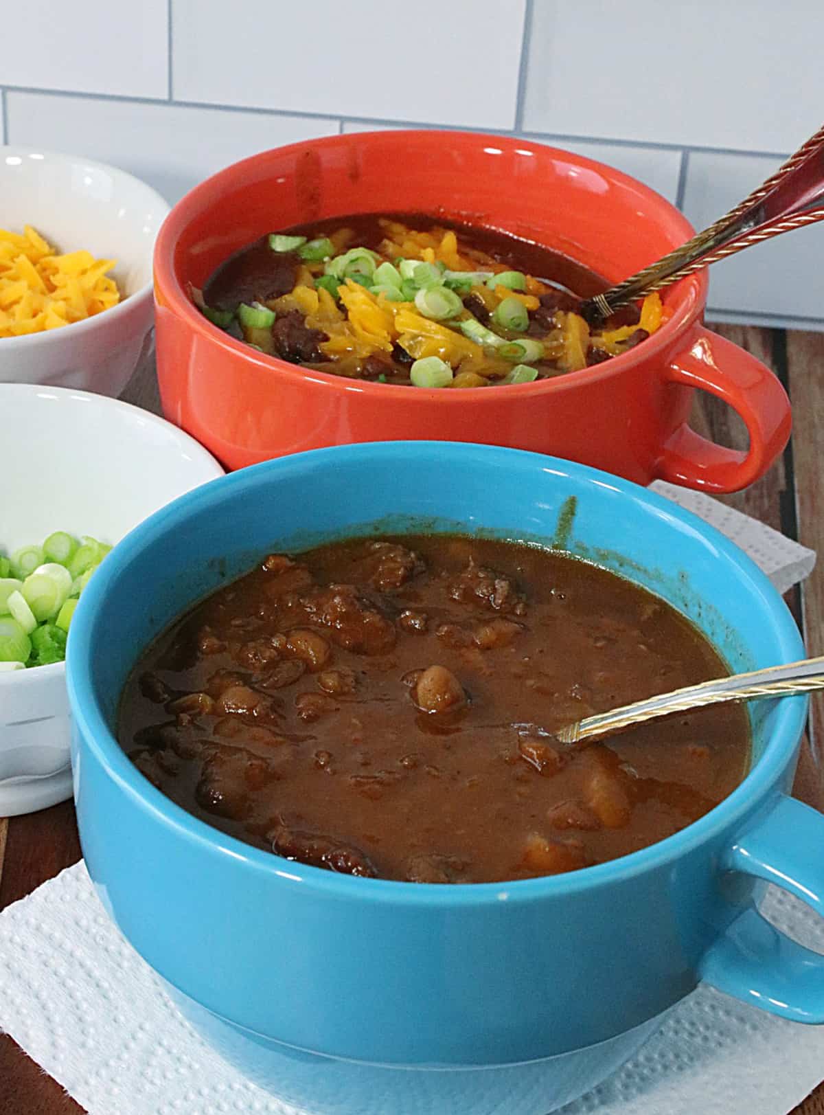 Two colorful soup bowls filled with Baked Bean Soup with Beef and Bacon.