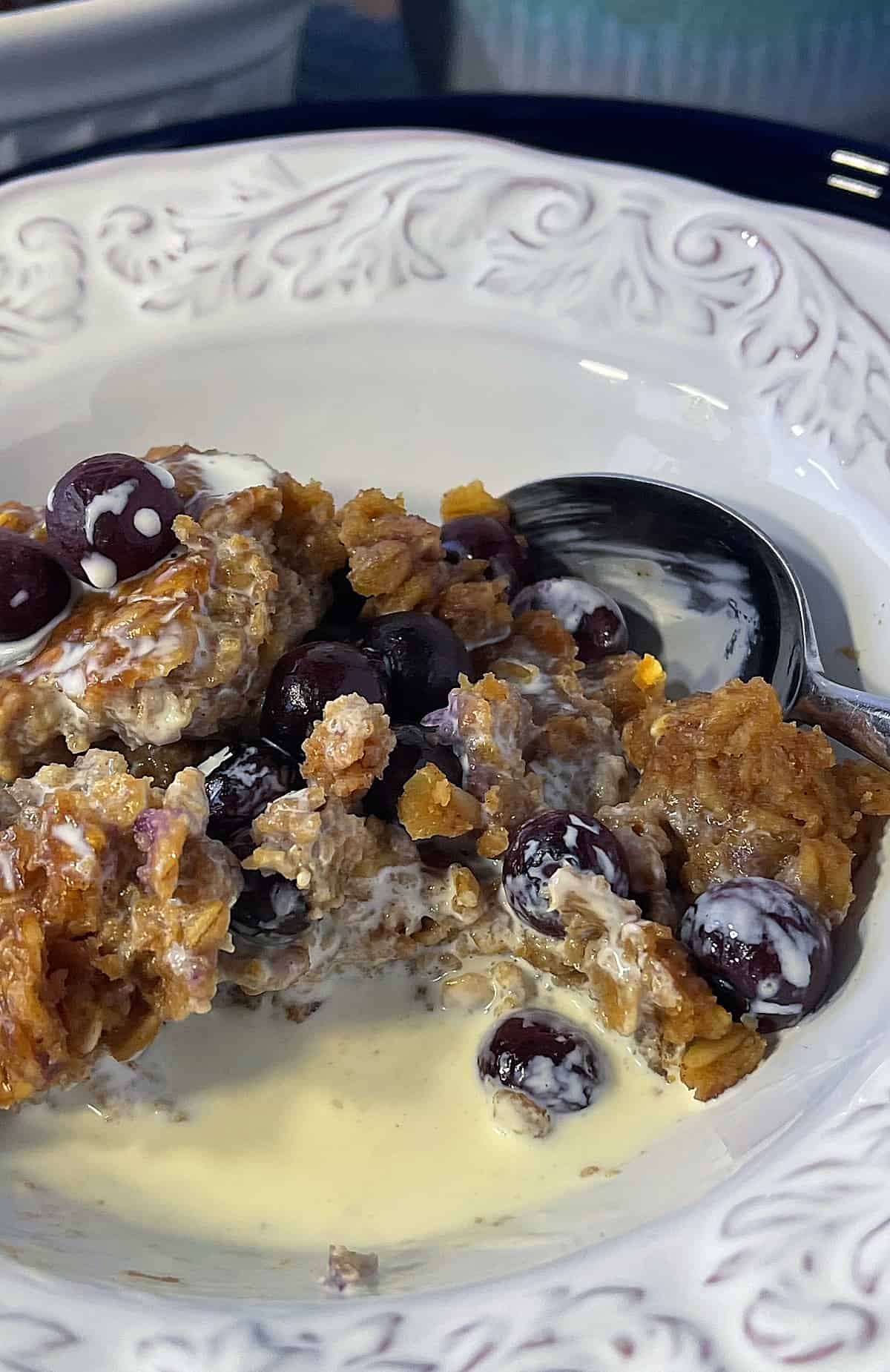 A serving of baked peanut butter and jelly oatmeal in a bowl with milk.