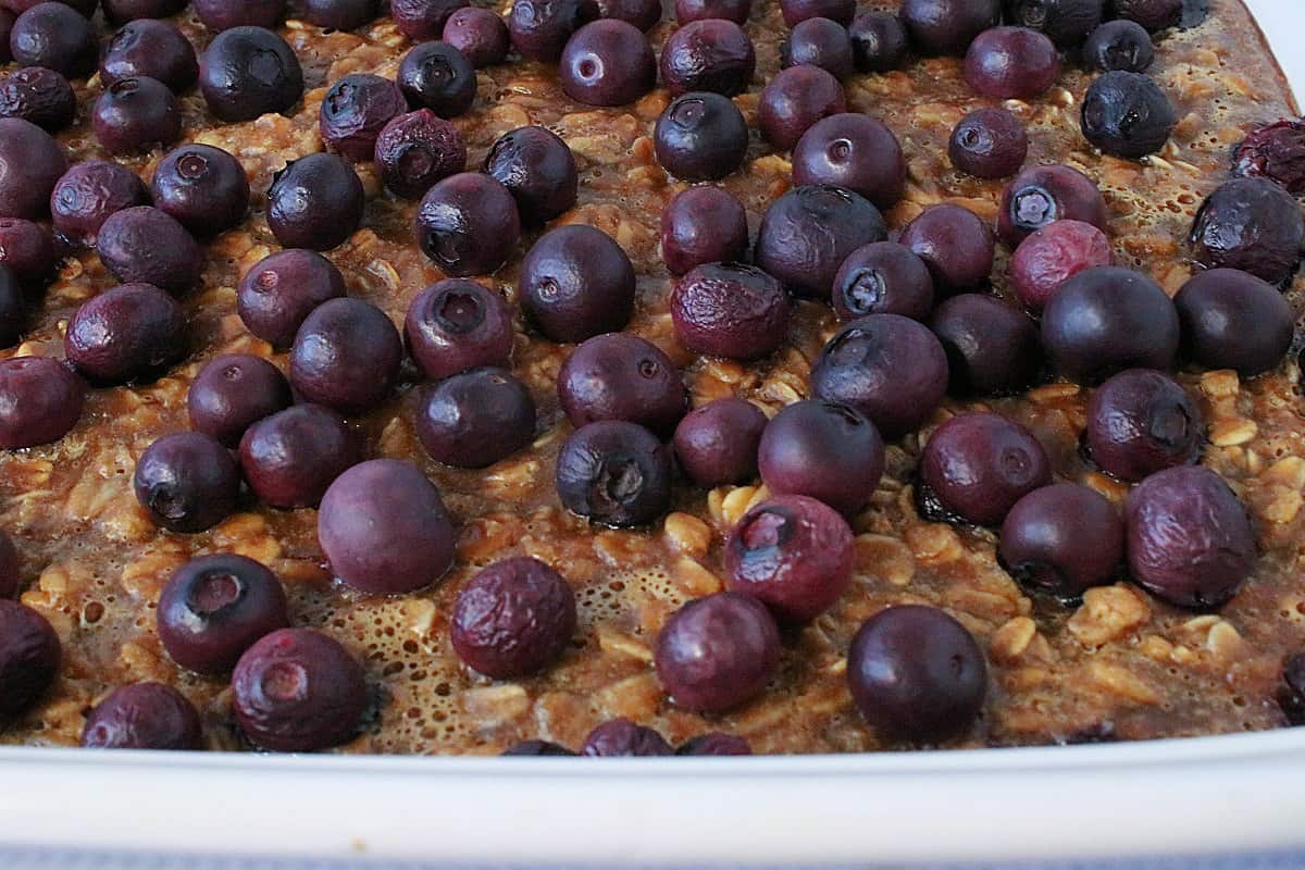 Fresh blueberries on top of a baked peanut butter and jelly oatmeal.