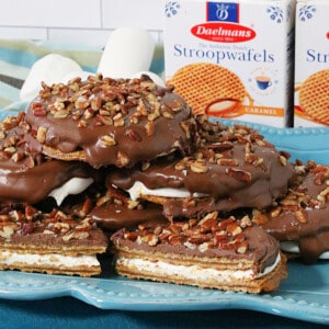 A stack of S'mores Stroopwafel Sandwiches on a blue plate.
