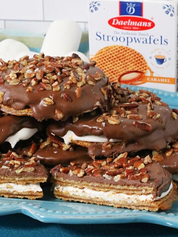 A stack of S'mores Stroopwafel Sandwiches on a blue plate.