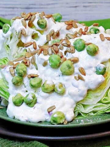 A green Wedge Salad with Wasabi Peas and Blue Cheese Dressing.