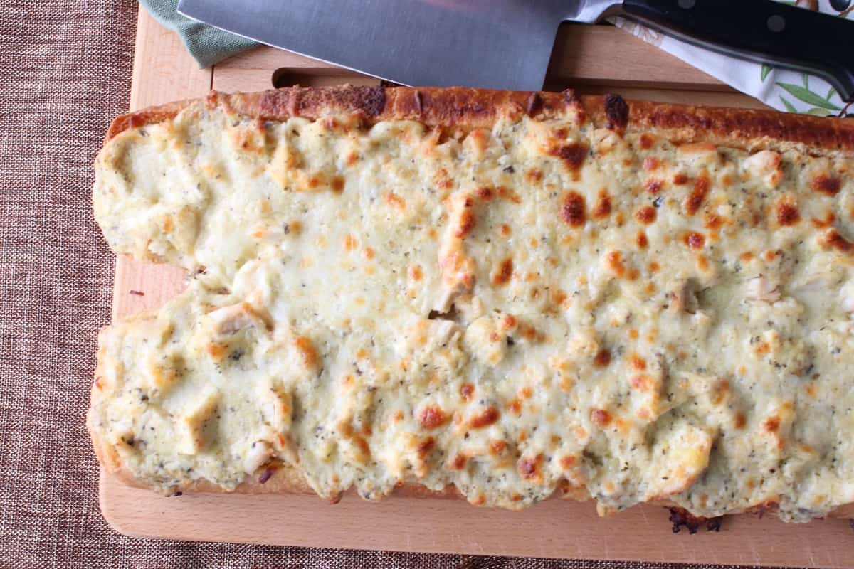 An overhead photo of cheesy Chicken Alfredo Garlic Bread Pizza.