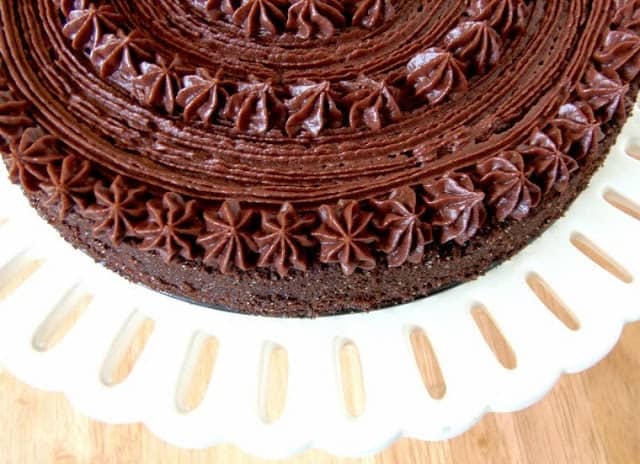 An overhead photo of a Chocolate Velvet Cake with pretty chocolate piping.