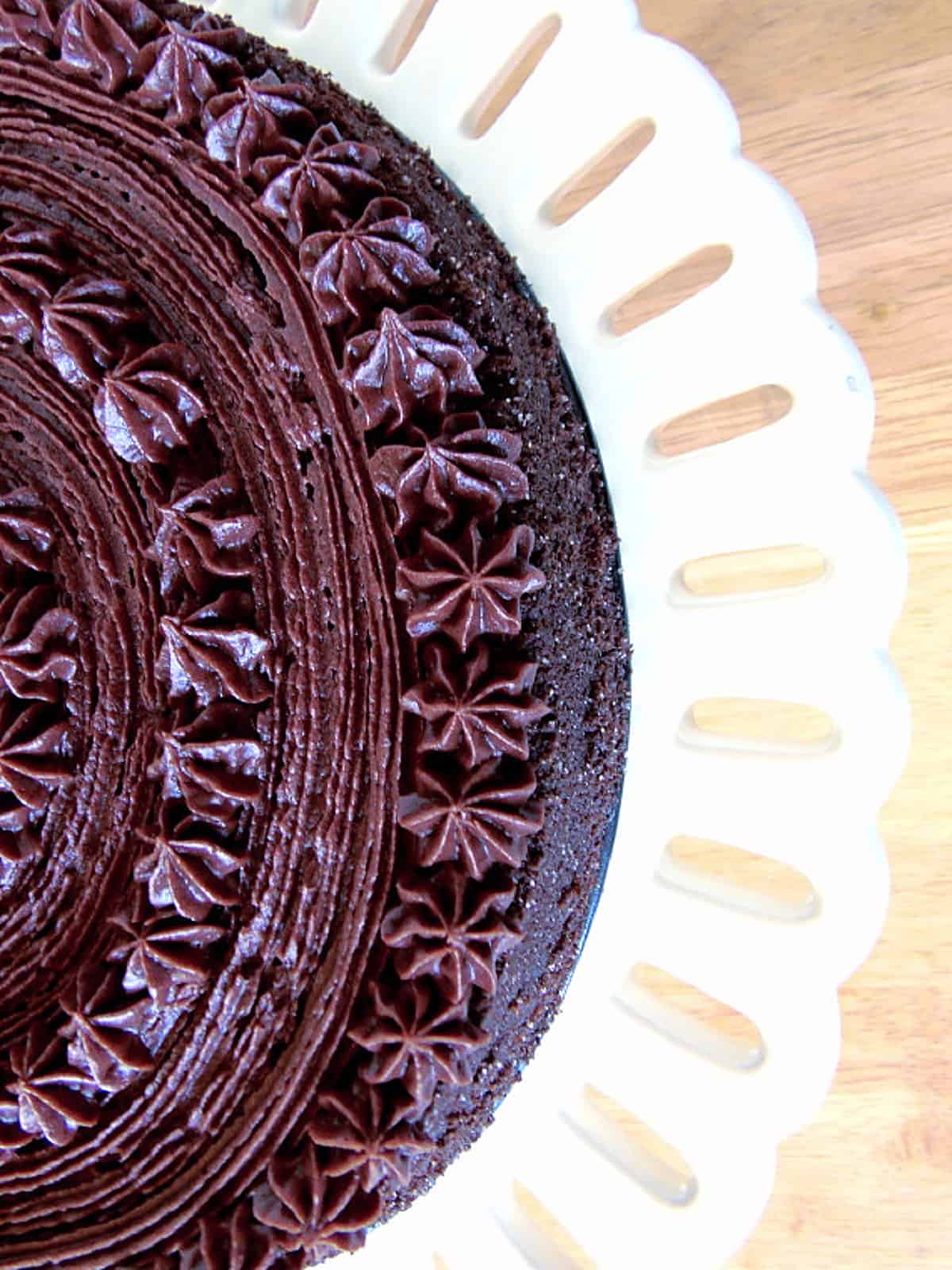 The top view of a Chocolate Velvet Cake with pretty chocolate buttercream piping.