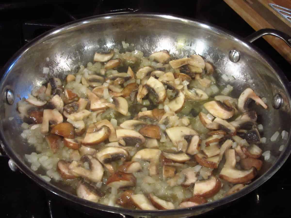 Sauteing mushrooms in a skillet.