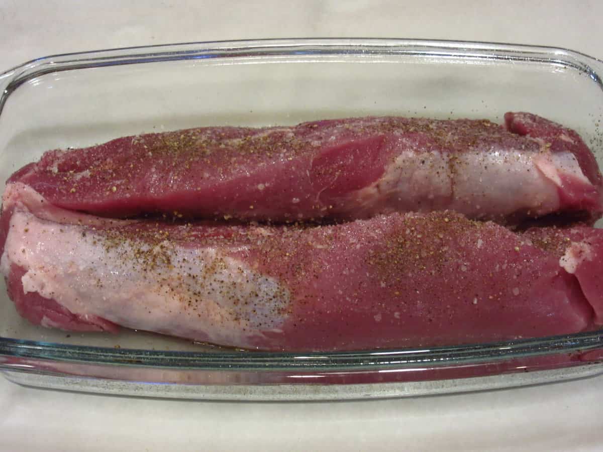 Pork tenderloin in a glass baking dish.