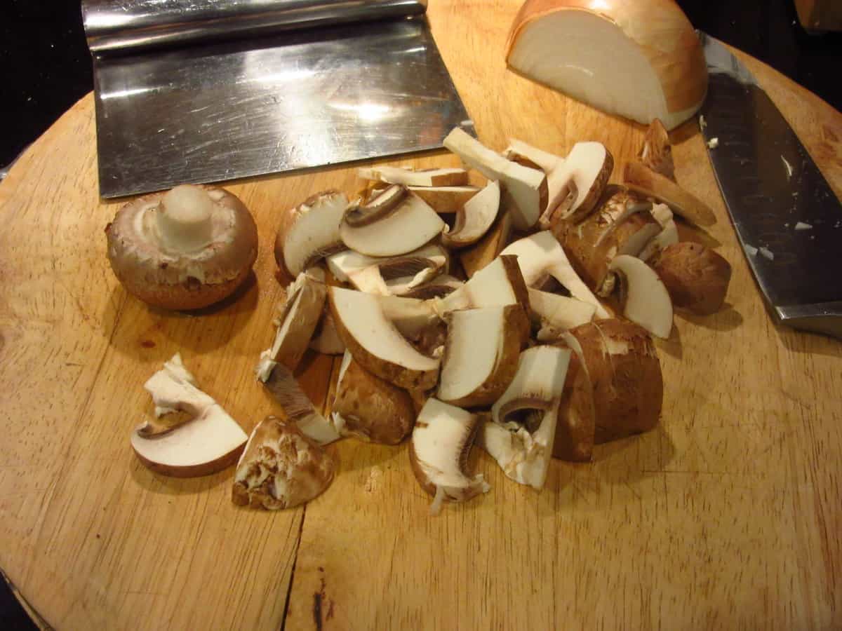 Sliced mushrooms on a cutting board.