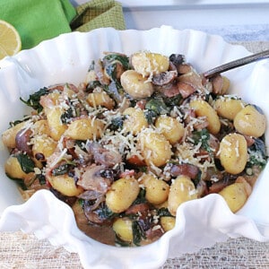 Potato Gnocchi with Spinach and Mushrooms in a pretty white bowl.