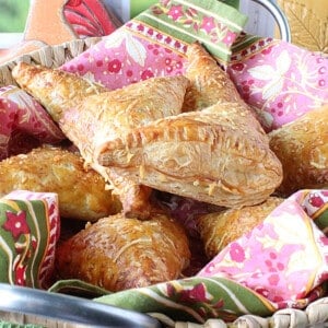 A pile of Chicken Pot Pie Turnovers in a colorful napkin.