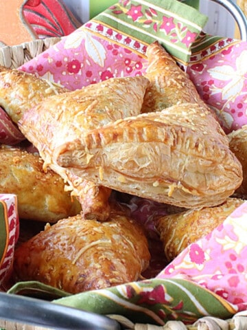 A pile of Chicken Pot Pie Turnovers in a colorful napkin.