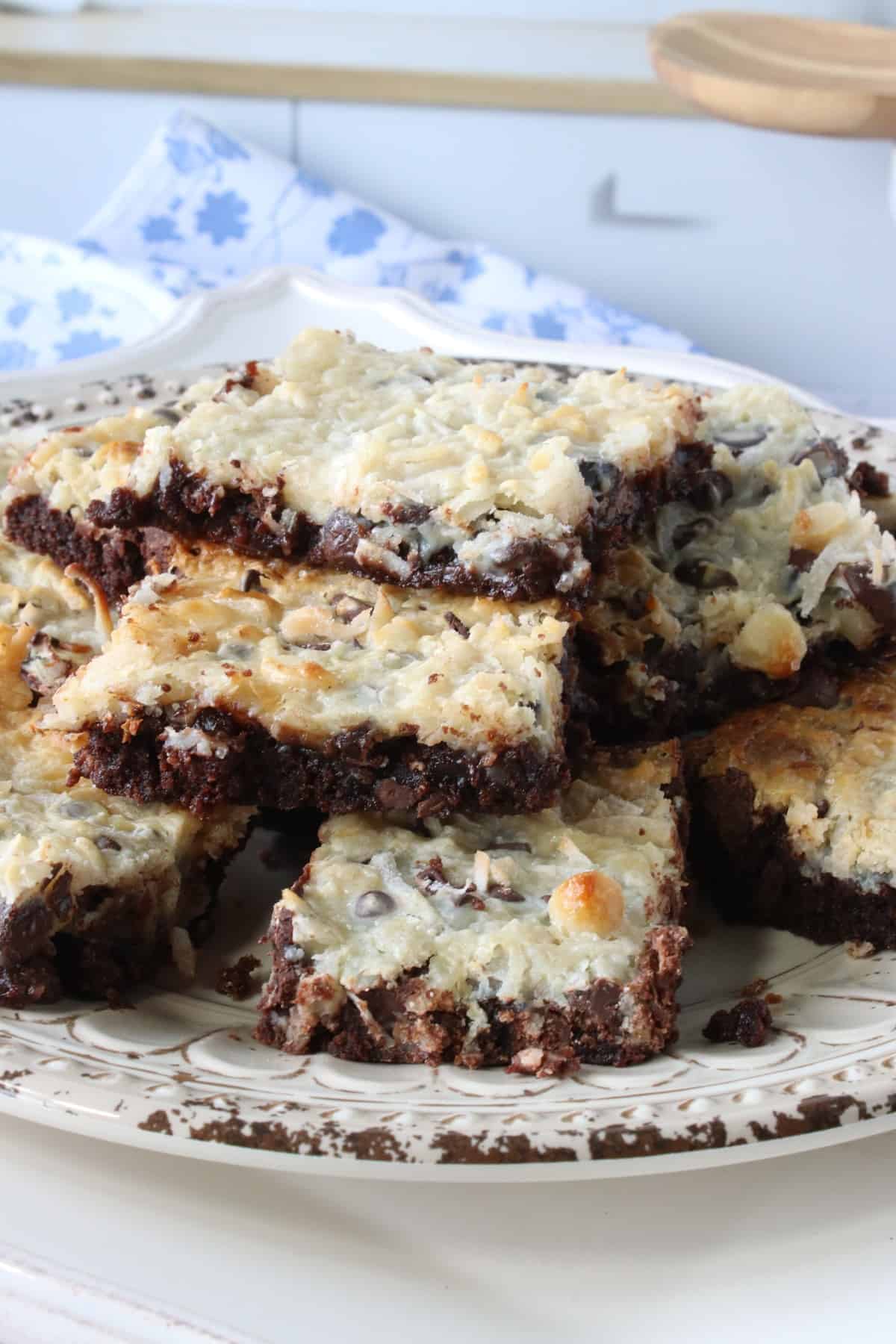 A stack of baked Coconut Brownies on a plate.