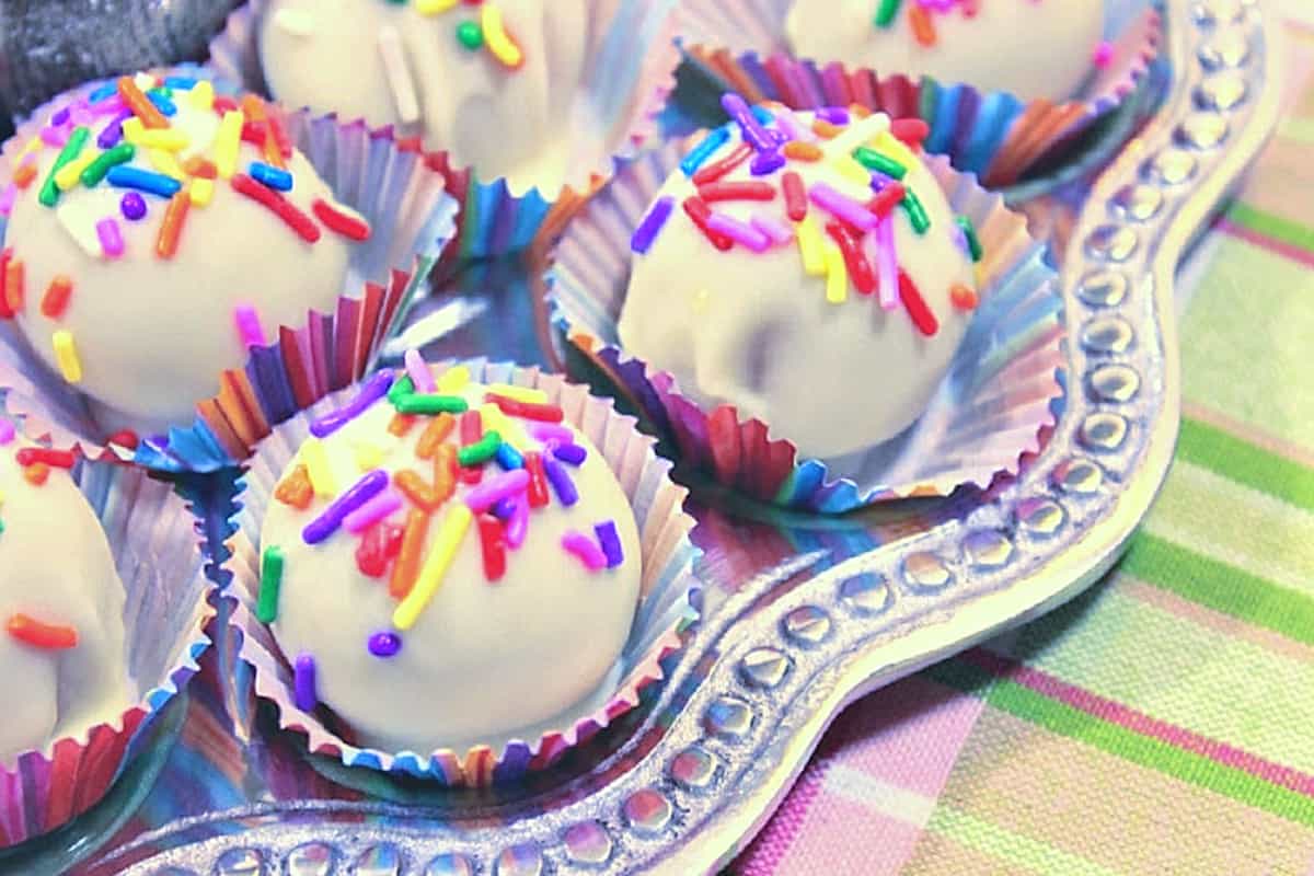 A silver tray filled with No-Bake Shortbread Cookie Truffles with colorful sprinkles on top.