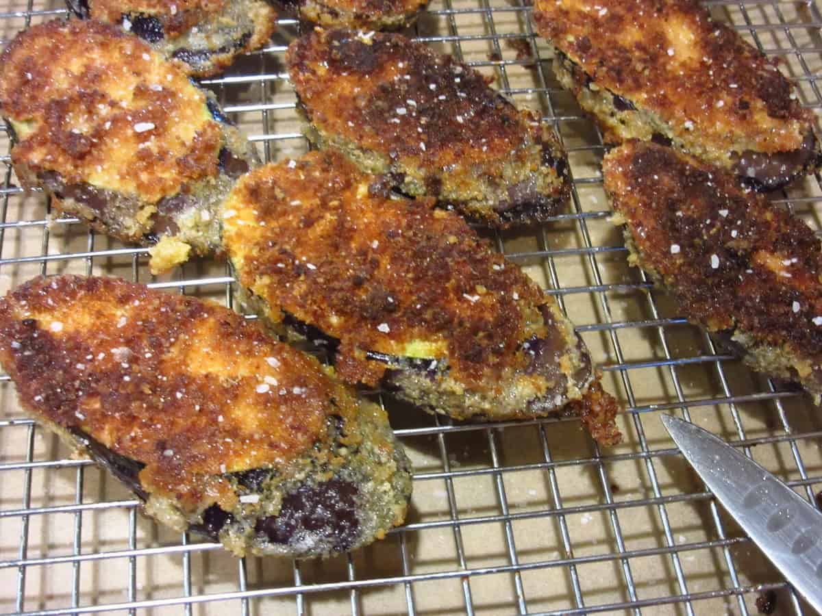 Breaded and fried eggplant slices to make a fried eggplant sandwich.