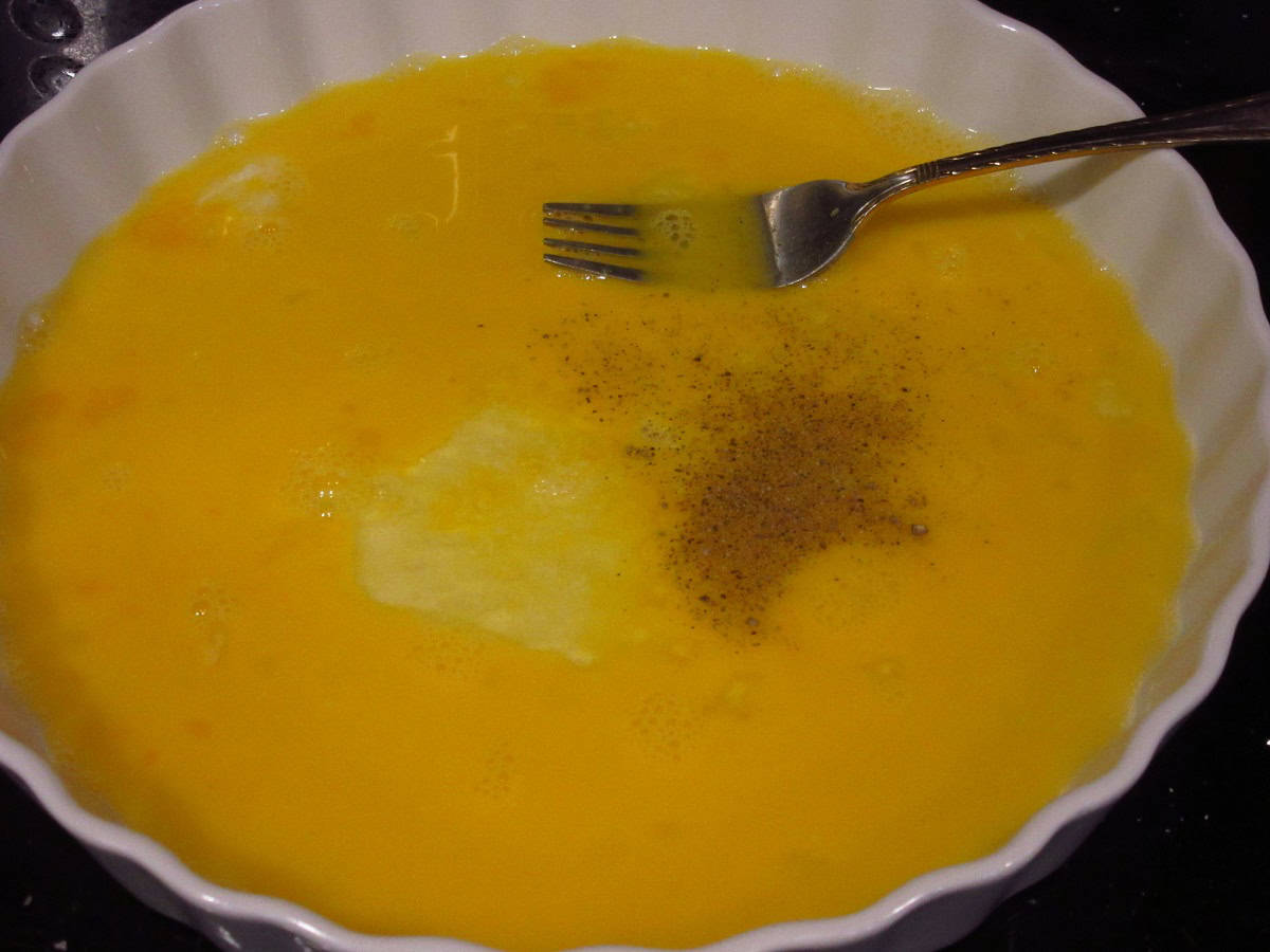 Beaten egg in a shallow pan with seasonings.