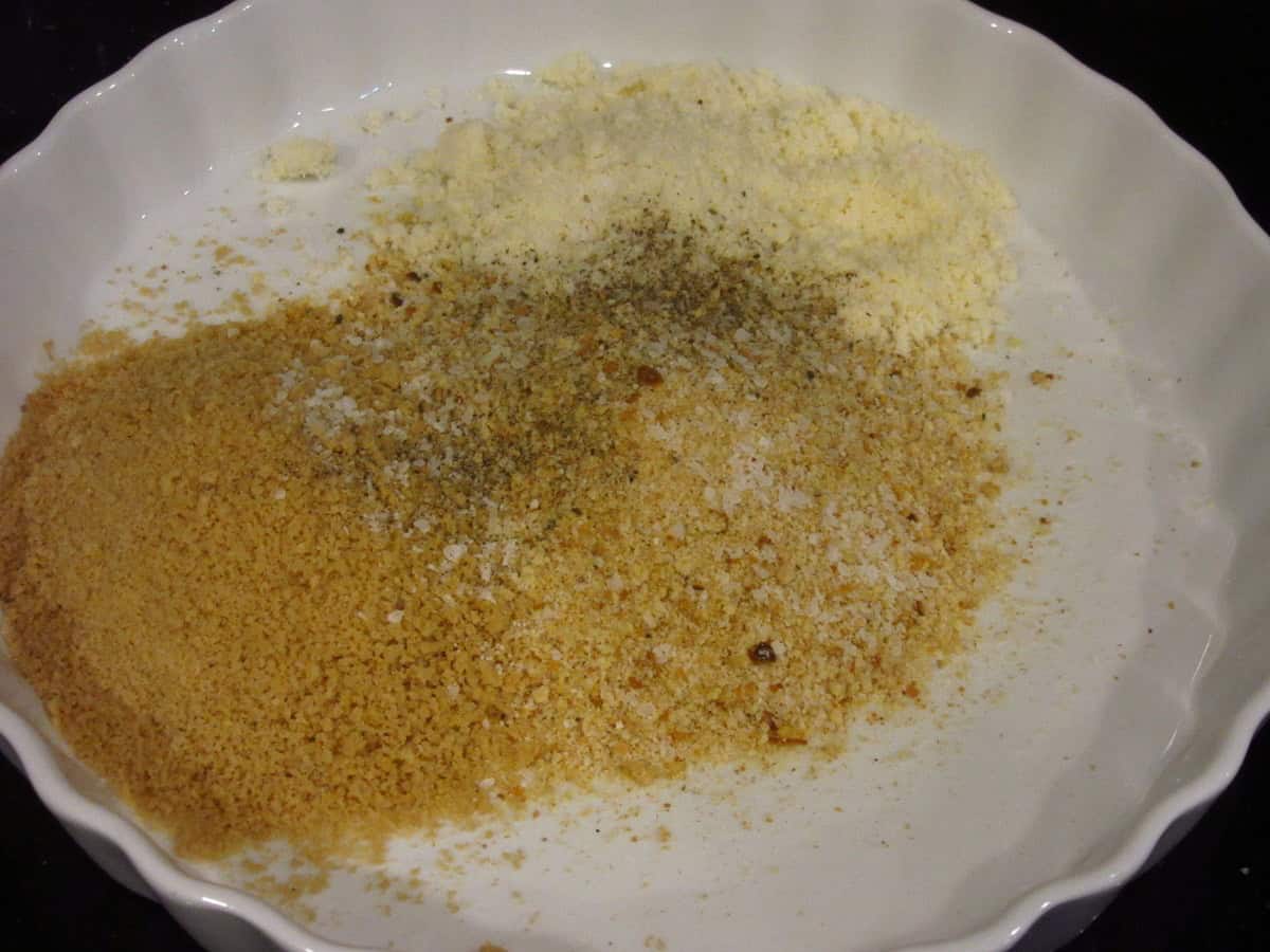 Breadcrumbs, panko, and cheese in a shallow dish.